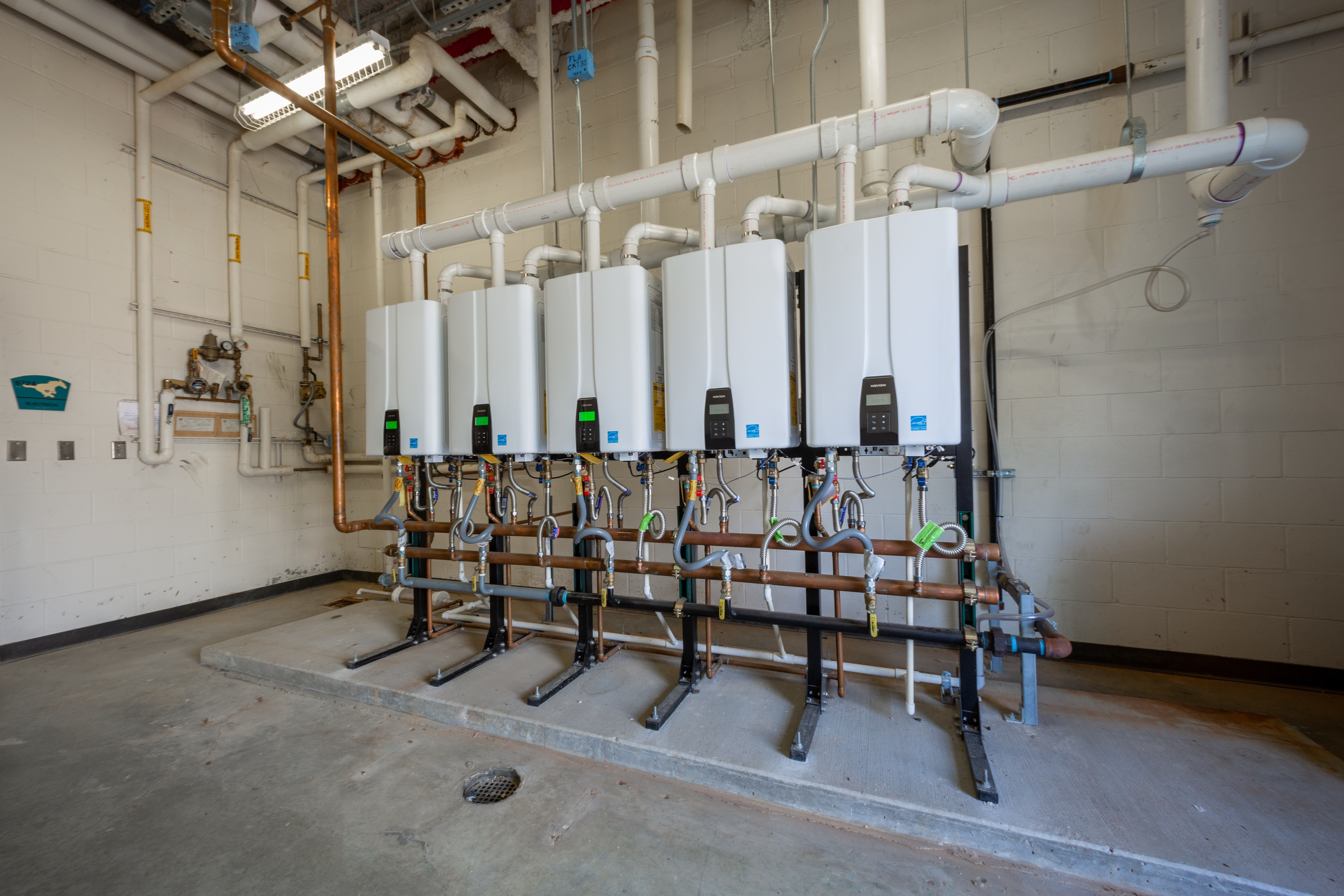 5 Navien NPE-240A2 tankless water heaters installed in the Pasadena TX high school fieldhouse